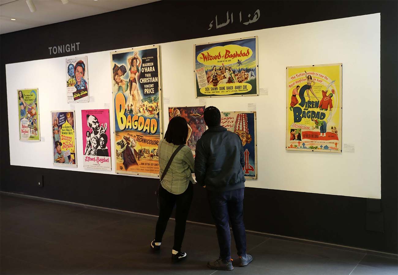Visitors observe vintage cinema posters displayed at an art exhibition in the Lebanese capital Beirut 