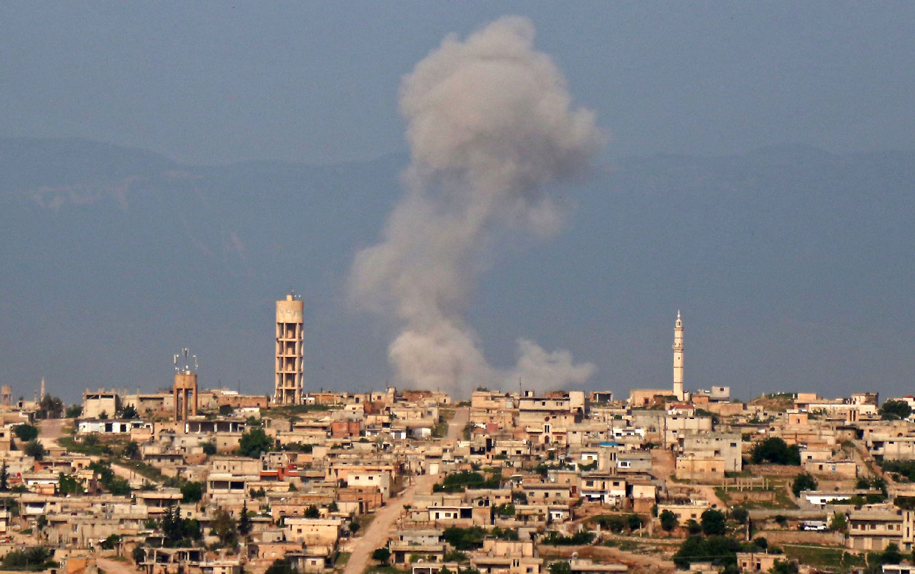 Smoke billows after reported shelling on the Syrian village of Kfar Nabouda in the northern countryside of Hama province