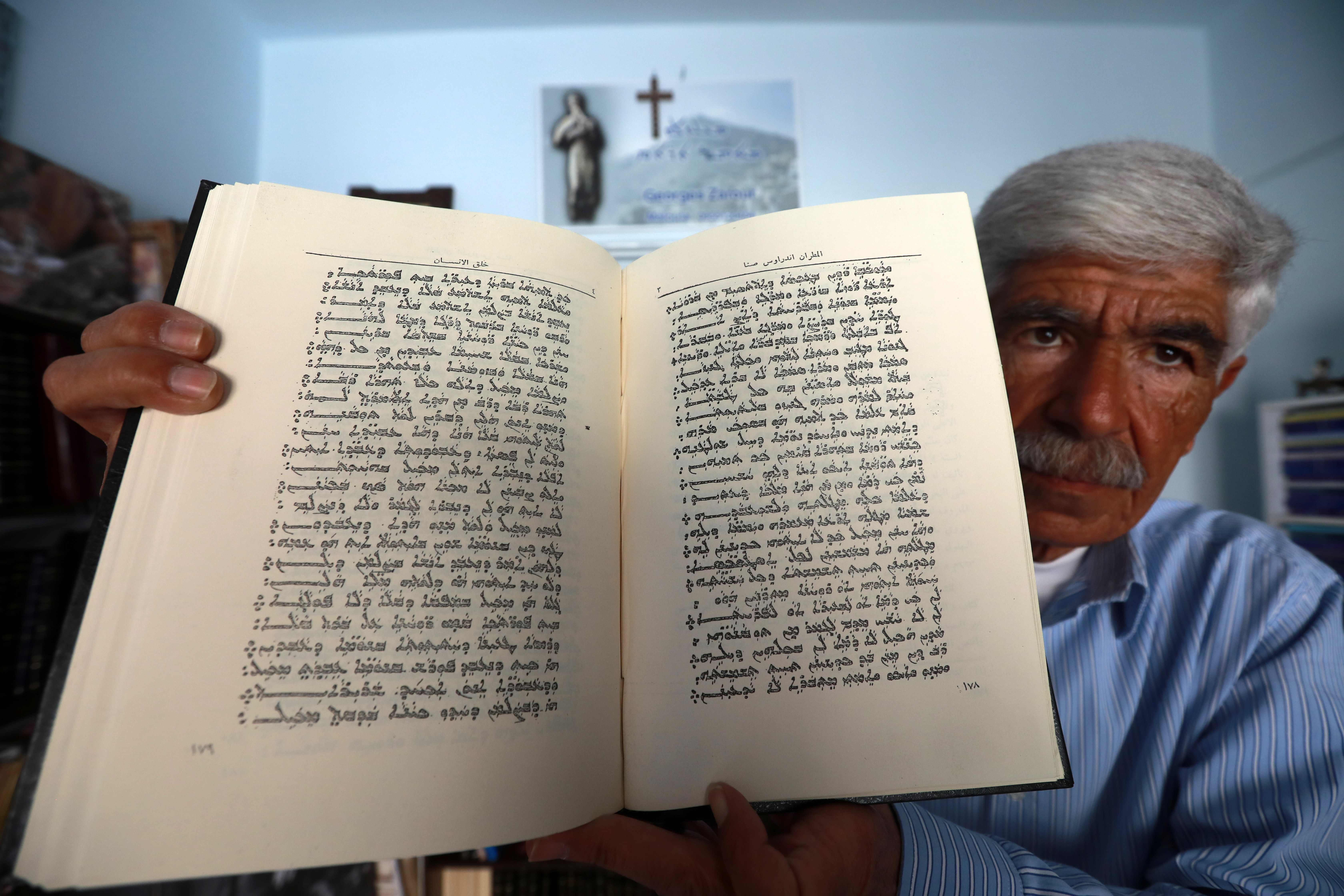 George Zaarour, a specialist in the Aramaic language, shows a book written in the Aramaic script