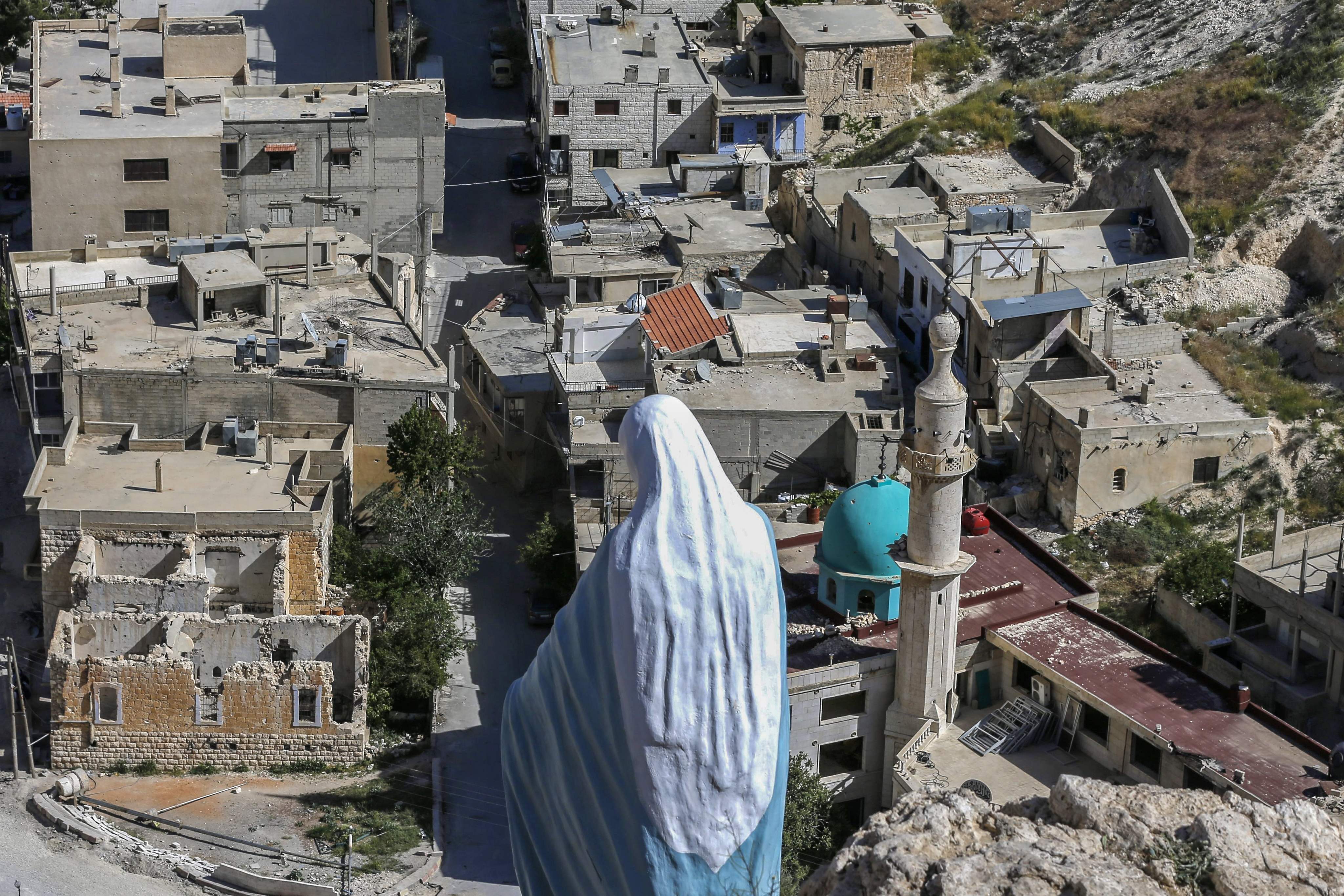 A statue of the Virgin Mary overlooks the ancient Christian town of Maalula