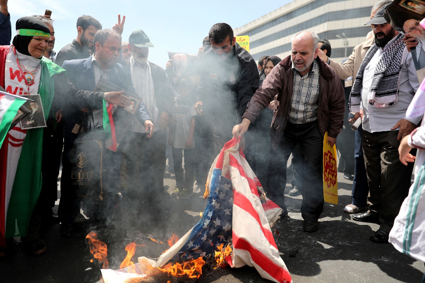 Iranians burn a US flag during a rally after Friday prayers in Tehran