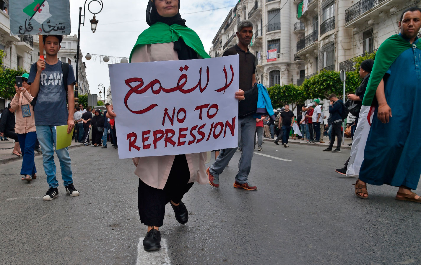 An Algerian protester carries a placard during an anti-government demonstration in the capital Algiers