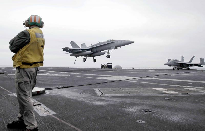  A US fighter jet lands on the USS Abraham Lincoln aircraft carrier during exercises in the Arabian Gulf