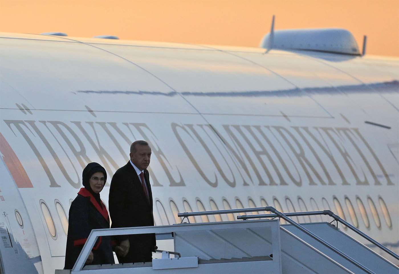Turkey's President Recep Tayyip Erdogan, accompanied by his wife Emine, arrives at Ataturk airport
