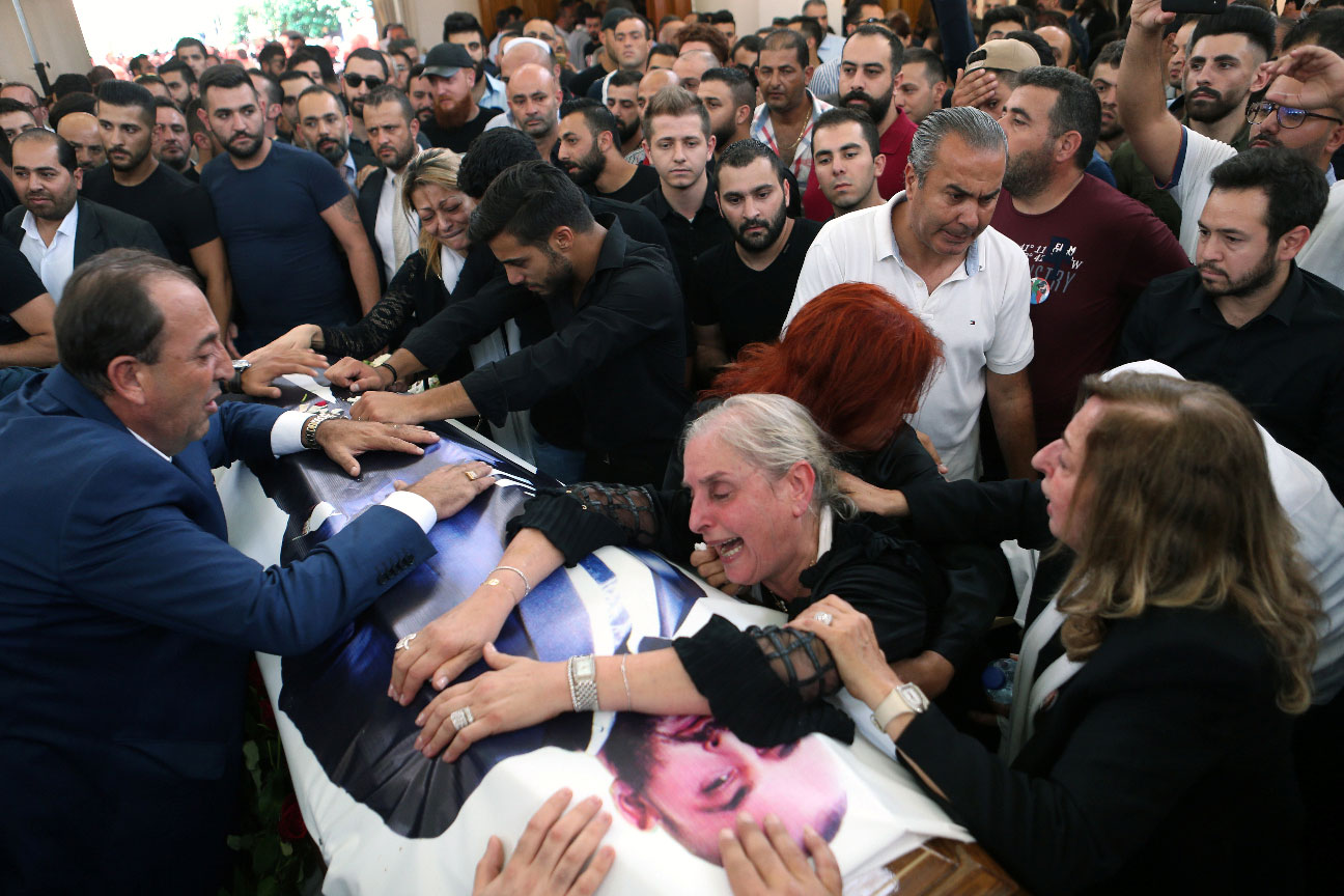 The mother and relatives of Rami Salman react during his funeral in Ramlieh, Lebanon