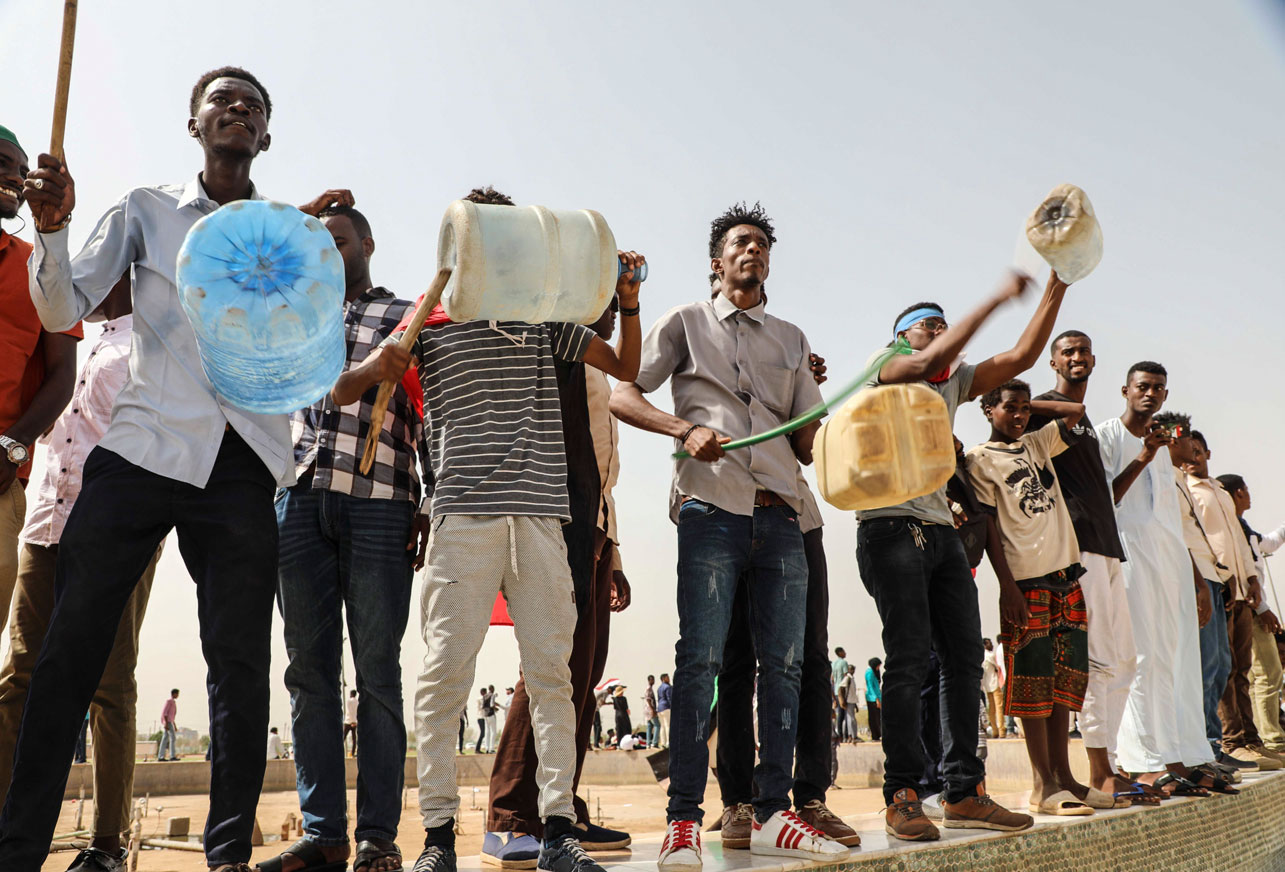 People take part in a protest condemning a deadly crackdown last month in Khartoum