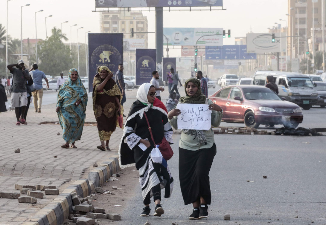 Sudanese protesters carry a placard during a rally in the capital Khartoum to condemn the killing of five demonstrators