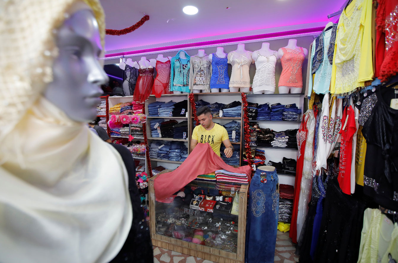 Syrian shopkeeper Mustafa is pictured at his clothes shop in Istanbul's Kucukcekmece district