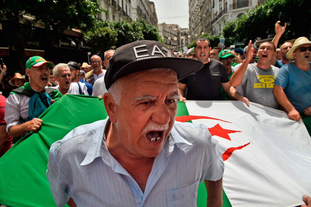 Algerian protesters shout slogans as they demonstrate in Algiers