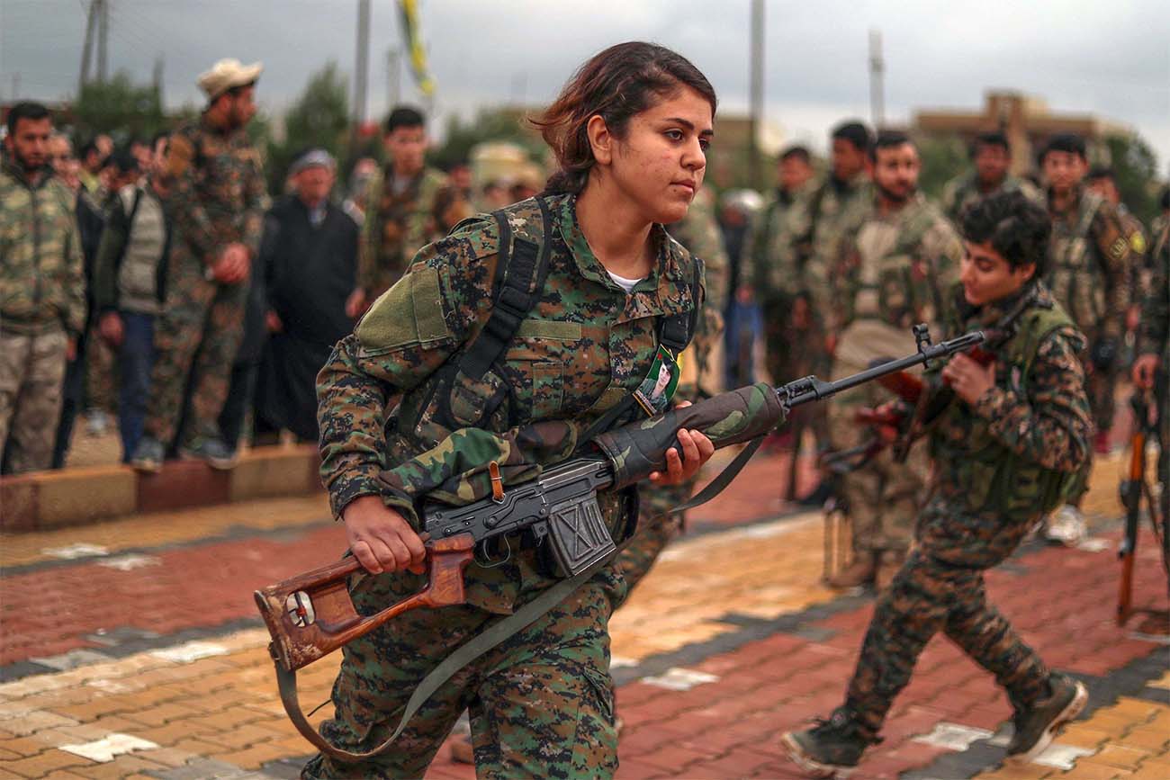 Fighters from the Kurdish women's protection units (YPJ) attend the funeral of a fellow fighter last February