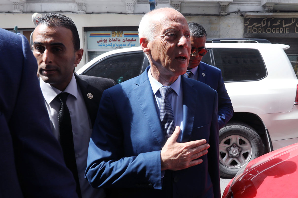 Presidential candidate Kais Saied arrives at his campaign headquarters