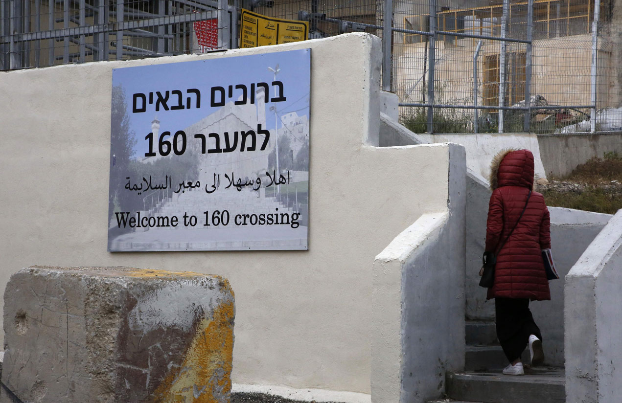 A Palestinian woman walks through the "160" checkpoint at the Ibrahimi Mosque in Israeli-occupied Hebron