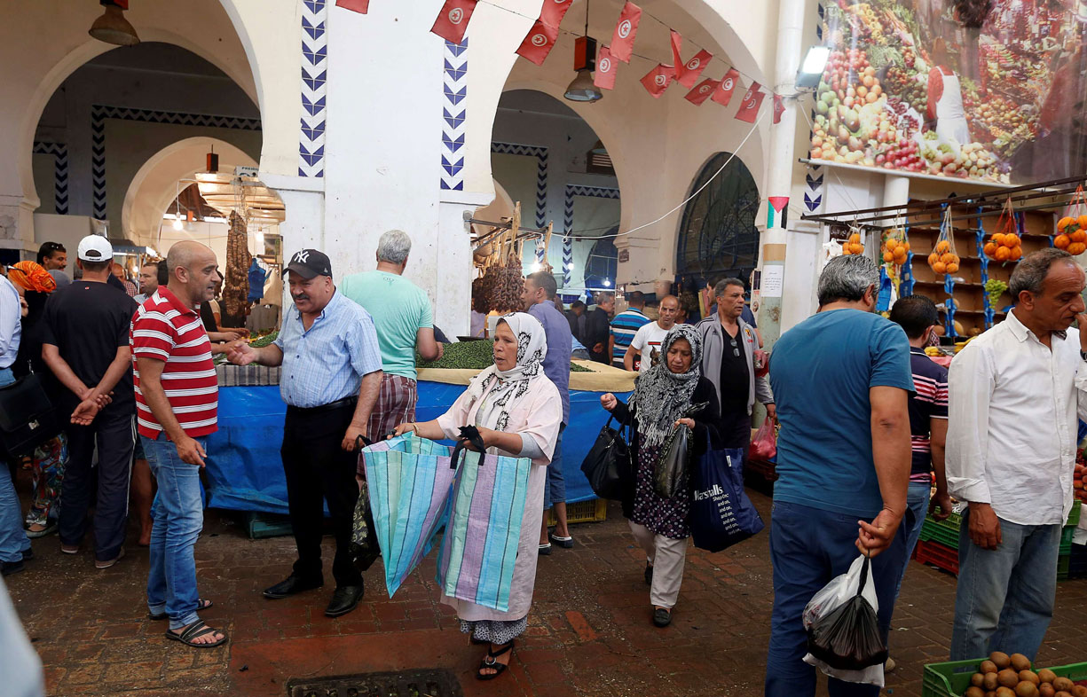 A woman sells plastic bags in a downtown market in Tunis