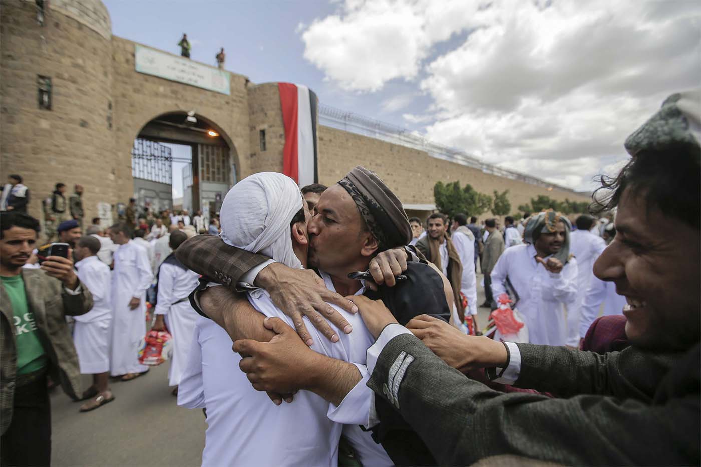 A Yemeni detainee is greeted by his relative and friends after his release from a prison controlled by Huthi rebels, in Sanaa