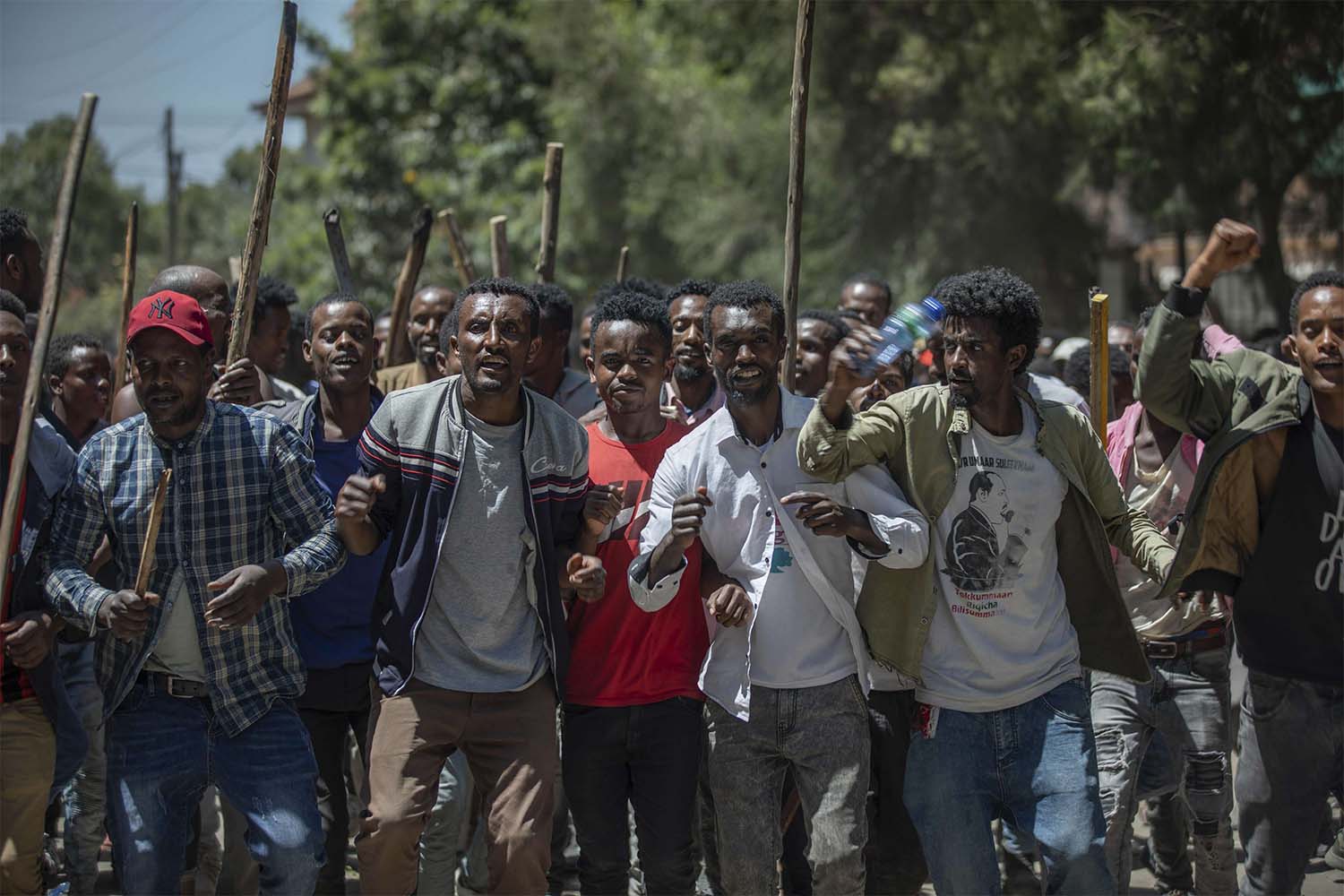 Protesters perform and shout slogans at the house of opposition leader Jawar Mohammed in Addis Ababa to show their support