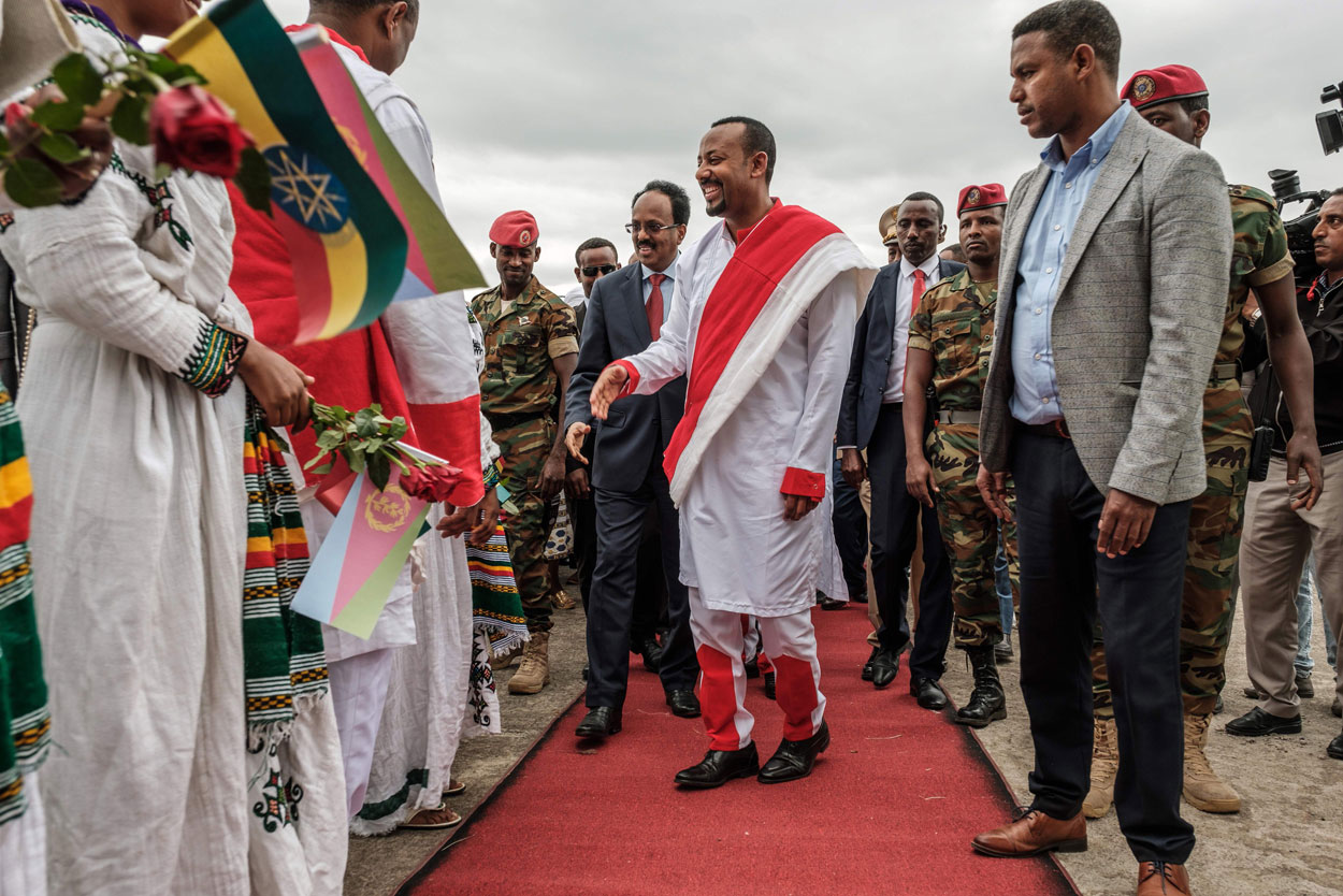 In this file photo taken on November 09, 2018 Somalia's president Mohamed Abdullahi Mohamed (CL) meets people accompanied by Ethiopia's Prime Minister Abiy Ahmed (CR)