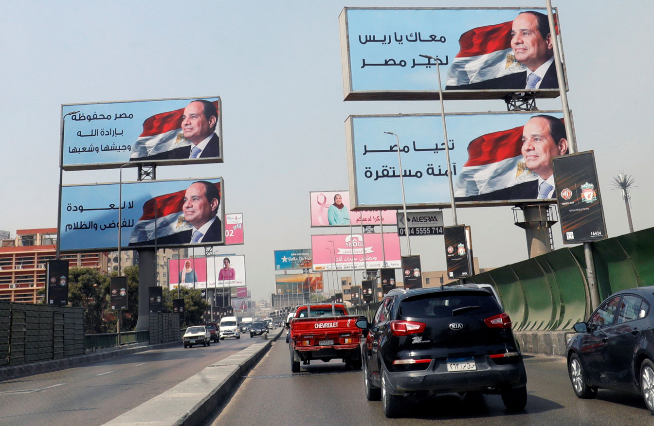 Cars move along the '6th October Bridge' near banners of Egyptian President Abdel Fattah al-Sisi