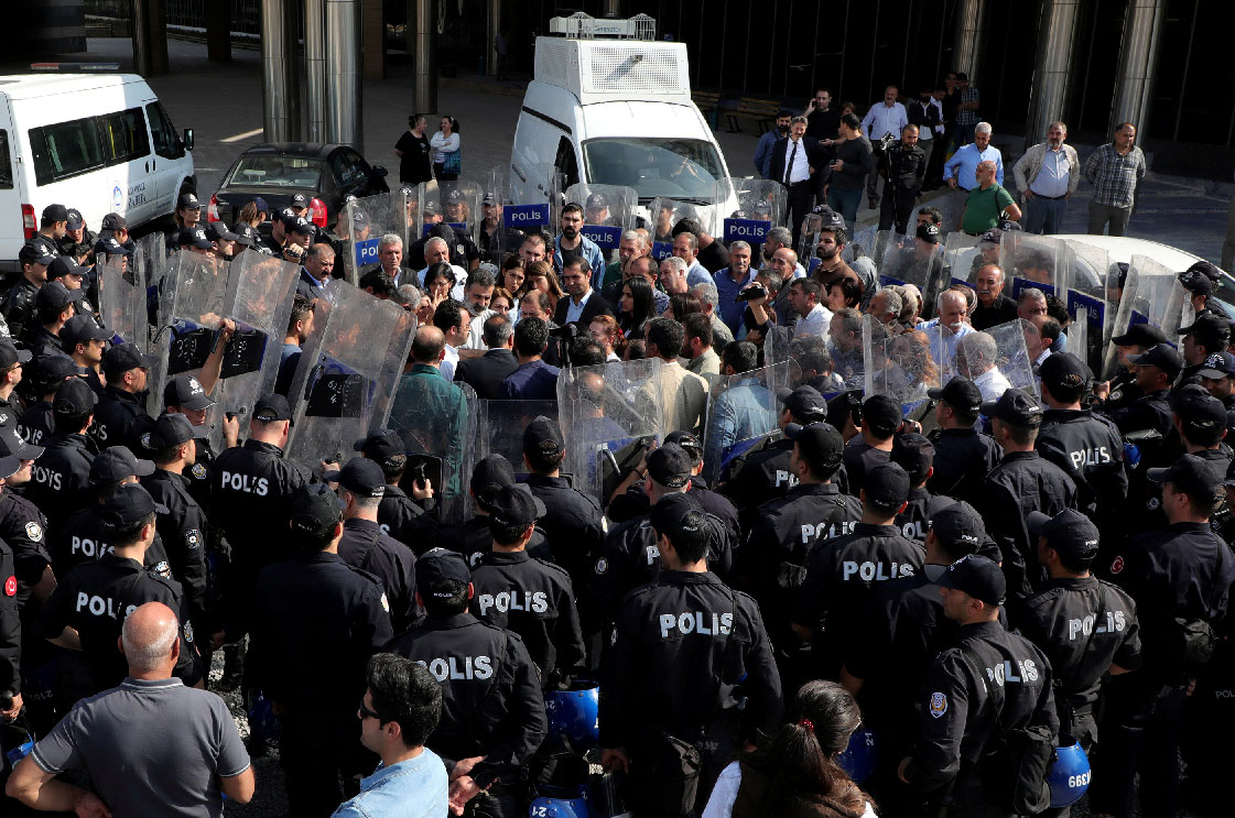 Peoples' Democratic Party (HDP) lawmakers are surrounded by riot police as they protest against detention of their local politicians in Diyarbakir