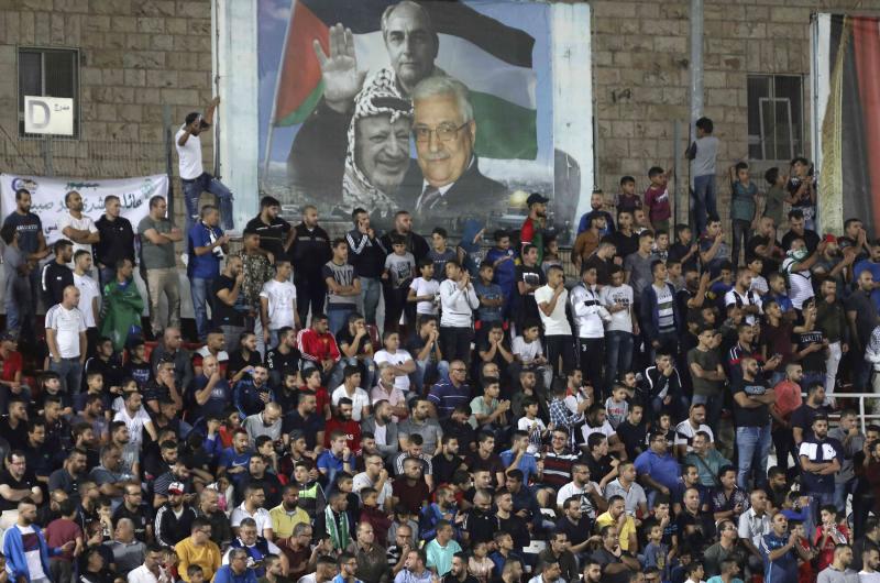 Spectators watch a match between Palestinian team Hilal al-Quds and Morocco's Raja Casablanca in the Arab Champions Cup at Faisal Husseini stadium in the town of al-Ram
