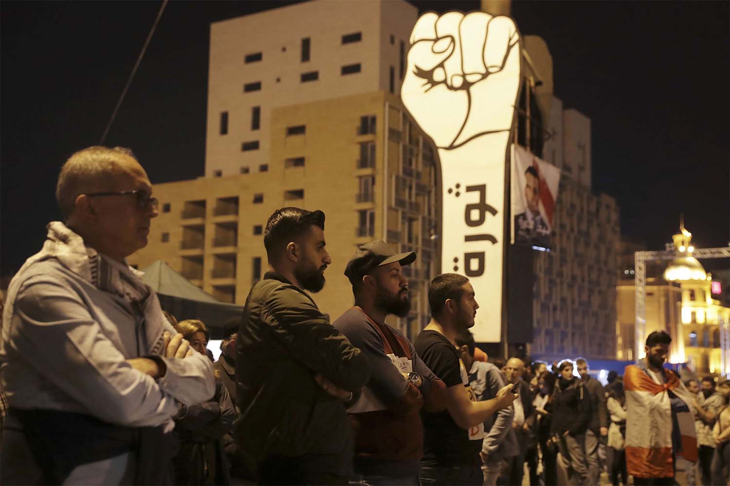 Anti-government protesters listen to Lebanese President's speech