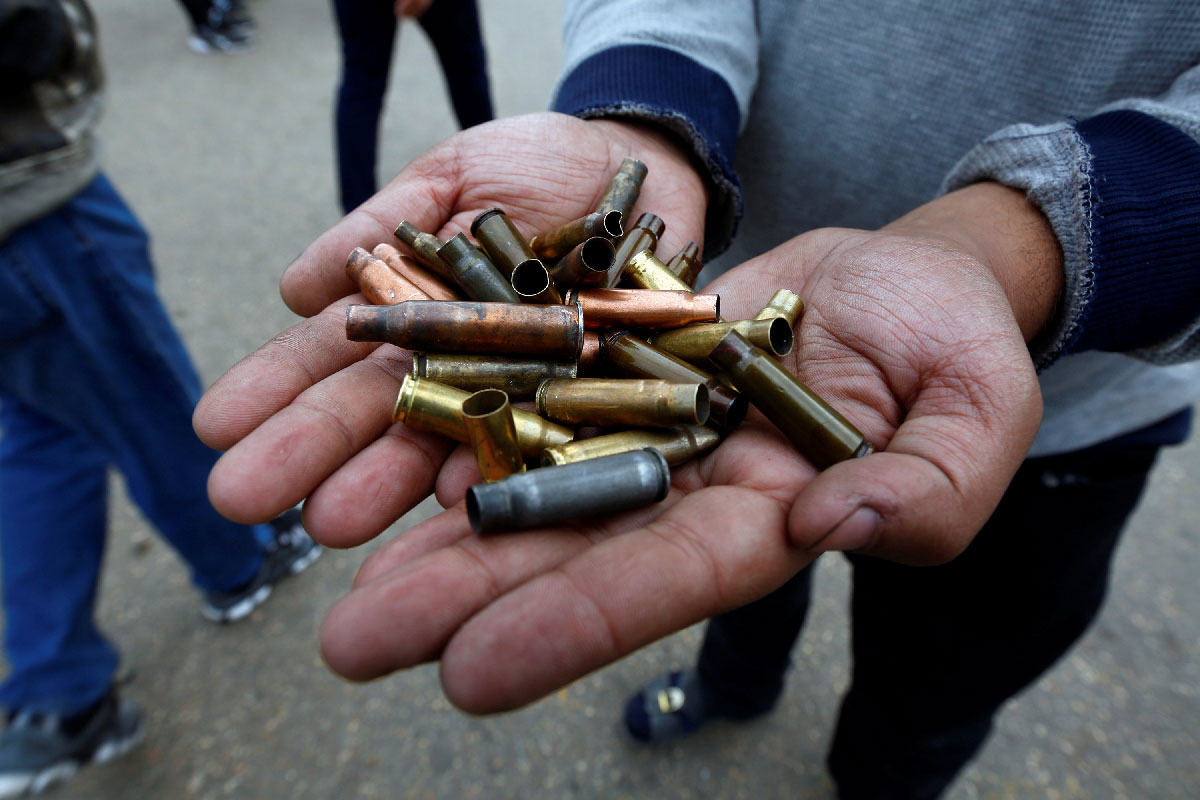 A man shows the casings from bullets which were used against protesters in Najaf