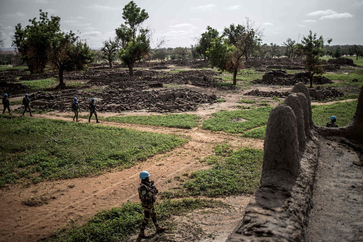 UN foot soldiers patrol in the destroyed Fulani village of Sadia-Peulh