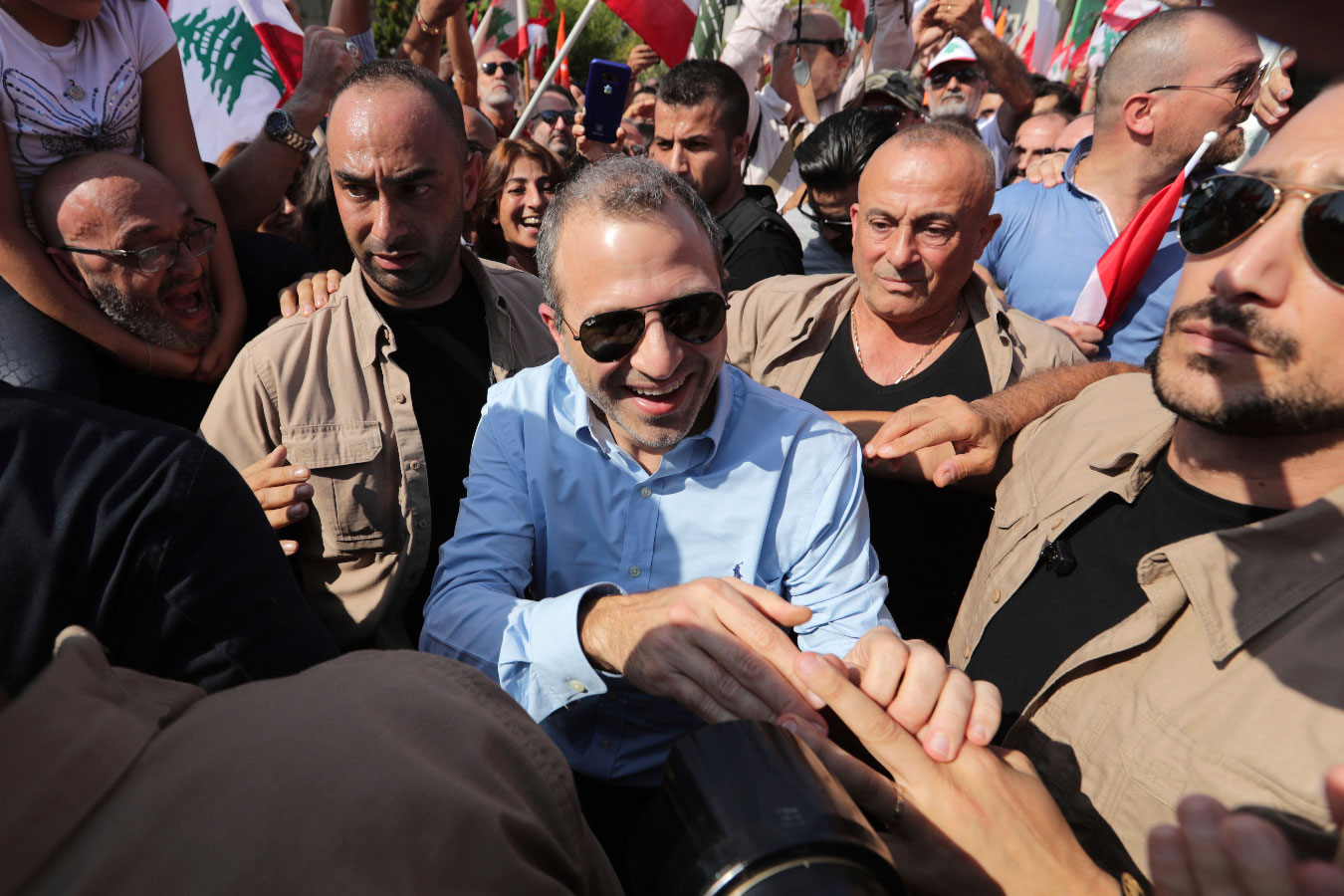 Lebanese Foreign Minister Gebran Bassil greets supporters during a protest near the presidential palace in Beirut