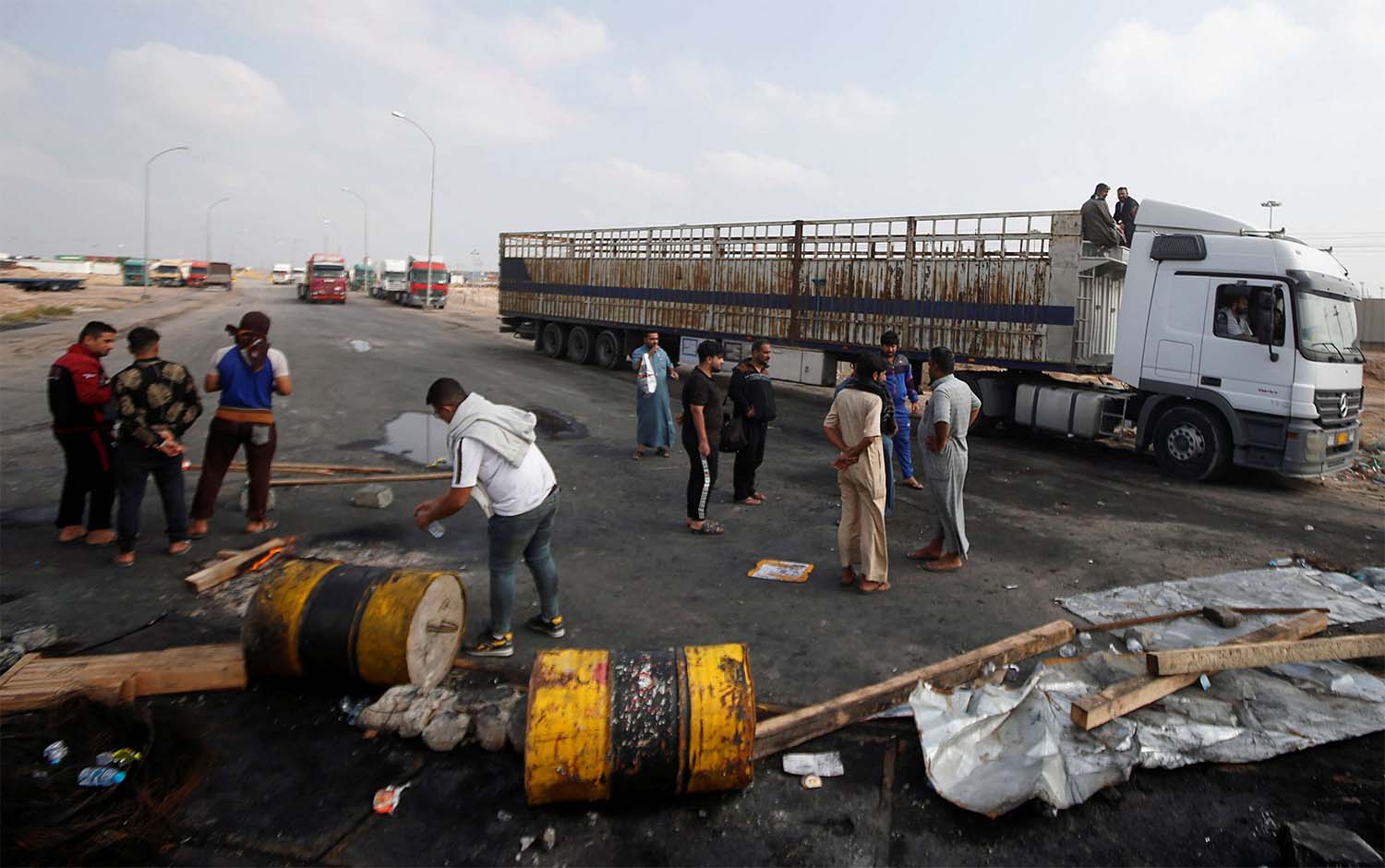 Iraqi demonstrators block the entrance to Umm Qasr Port during the ongoing anti-government protests