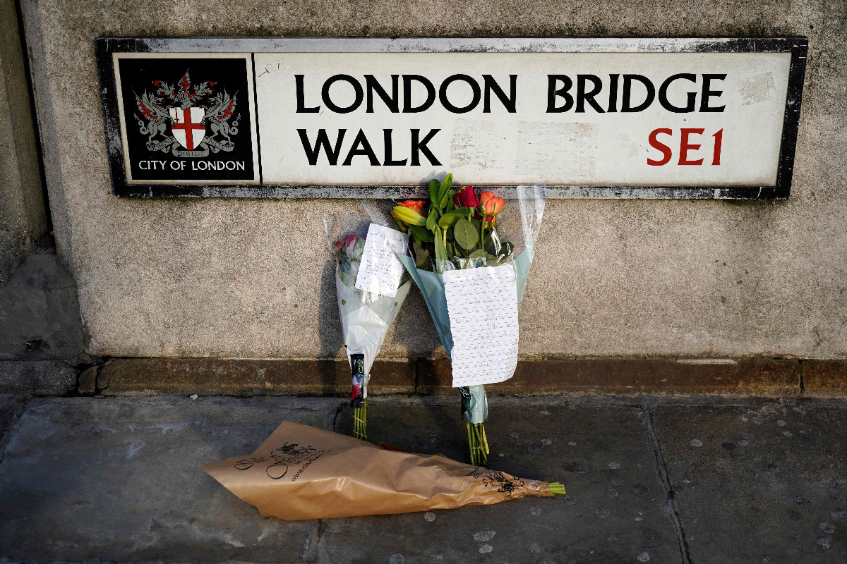 Floral tributes are pictured close to London Bridge in the City of London