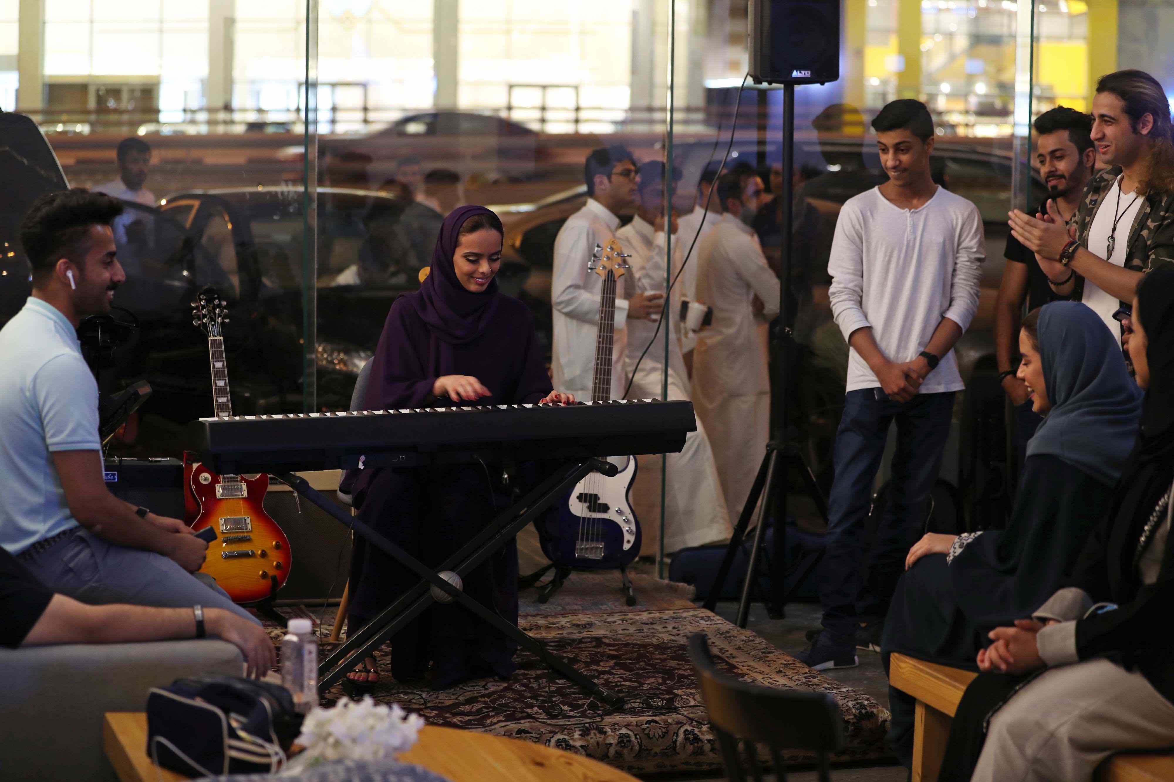 Saudi female musician Lojain Sami plays a keyboard at a local cafe in Khobar.