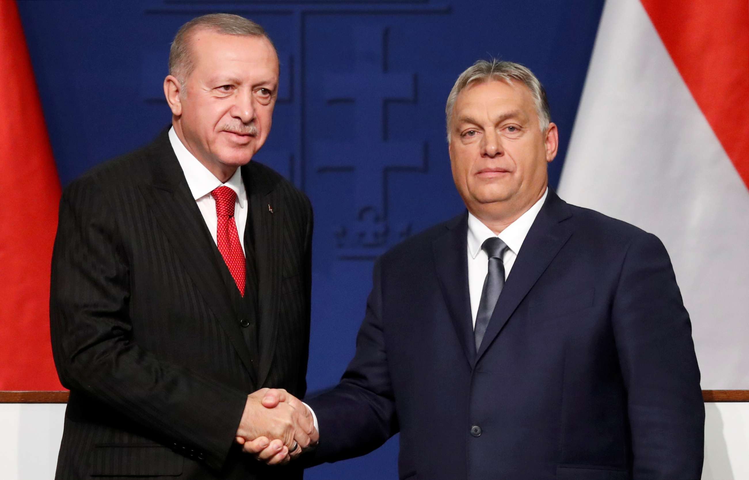 Turkish President Recep Tayyip Erdogan and Hungarian Prime Minister Viktor Orban shake hands during a news conference in Budapest