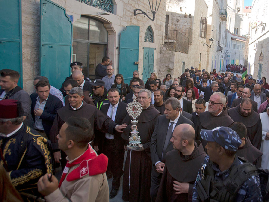 Christian clergymen carry a wooden relic believed to be from Jesus' manger in the Palestinian city of Bethlehem