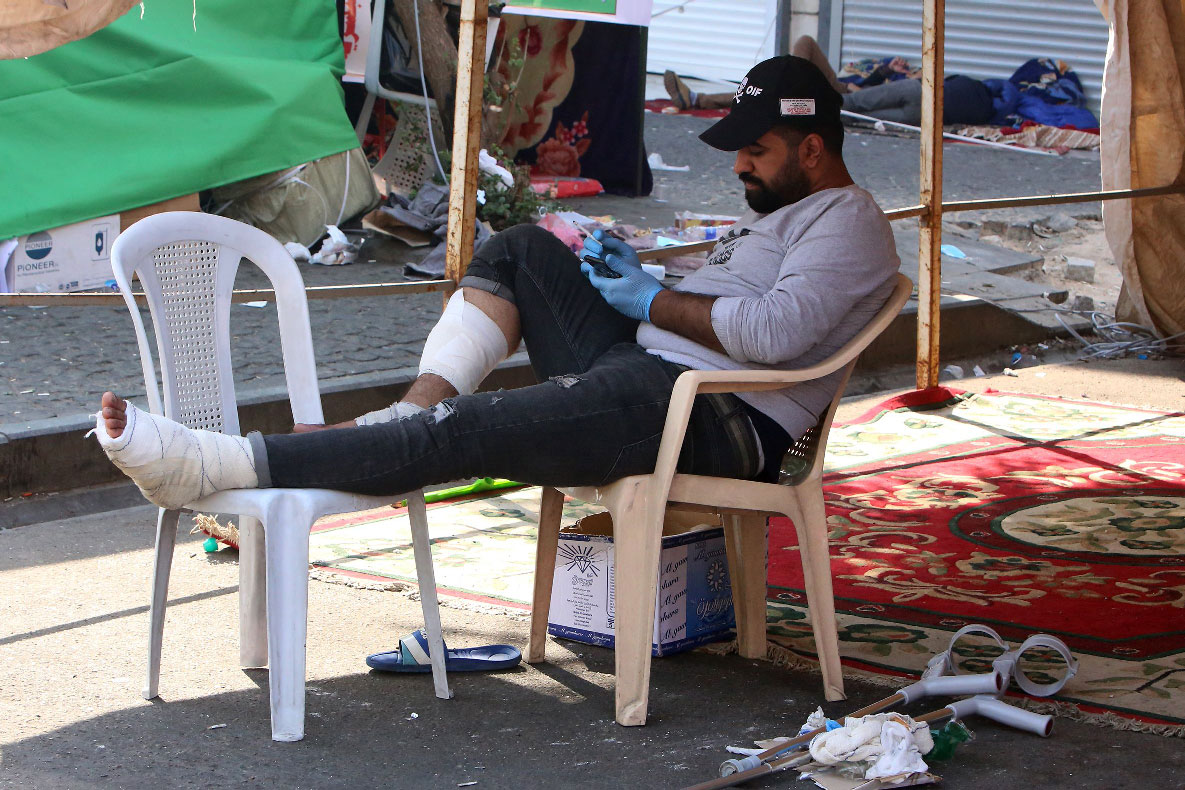 A wounded Iraqi protester resting under a tent in al-Khalani square in central Baghdad 