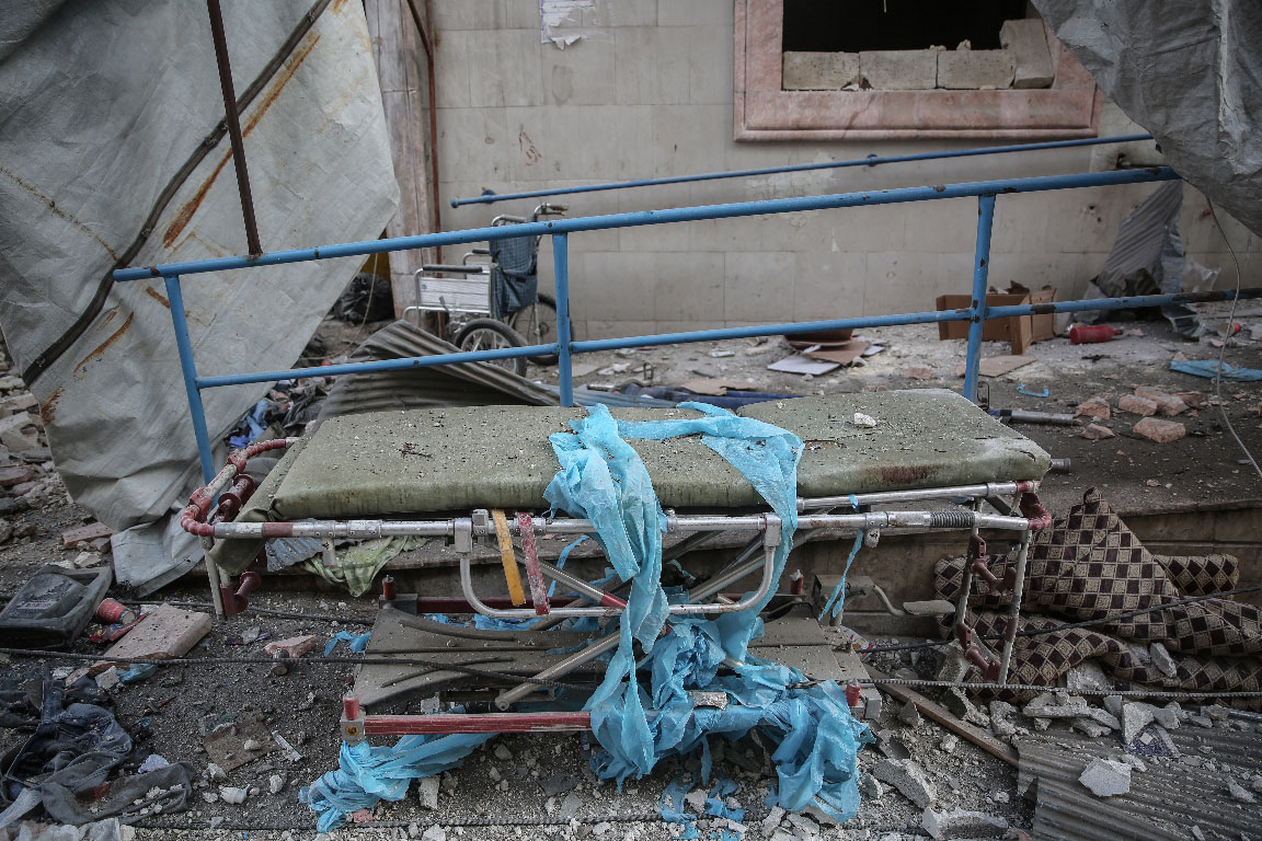 A hospital bed lies amongst the rubble of the damaged Shami Clinic in Ariha