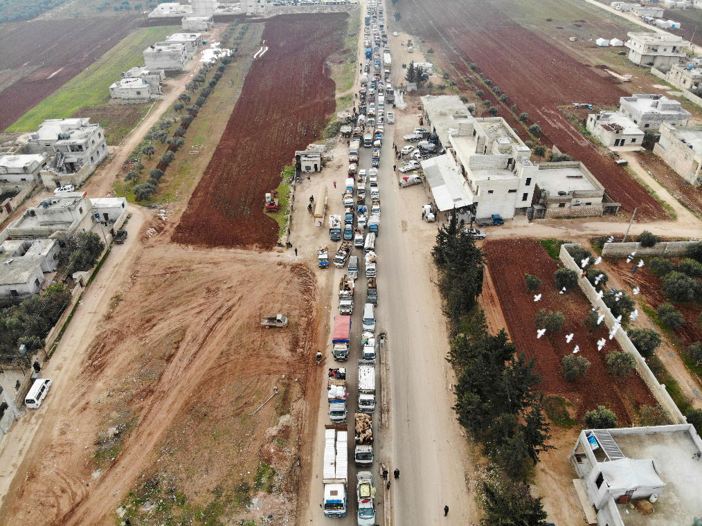 A aerial photo shows displaced Syrians driving through Hazano in the northern countryside of Idlib