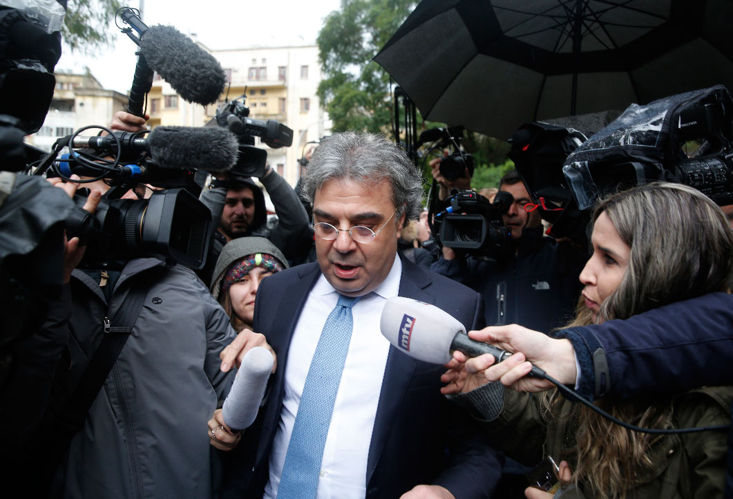 Carlos Abou Jaoude, center, a lawyer for ex-Nissan chief Carlos Ghosn, speaks to journalist as he leaves the judicial palace in Beirut