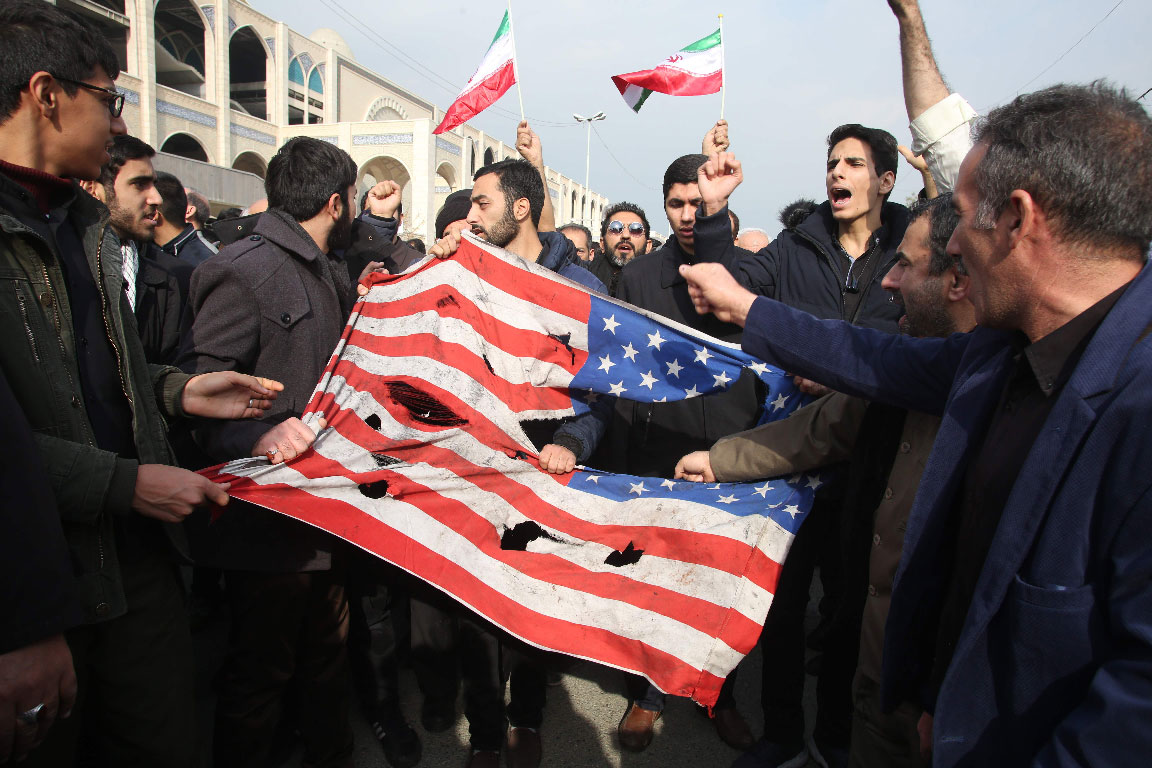 Iranians tear a US flag during a protest in Tehran