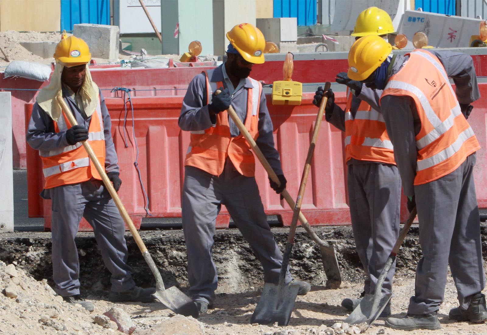 Workers are seen at a construction site in Doha