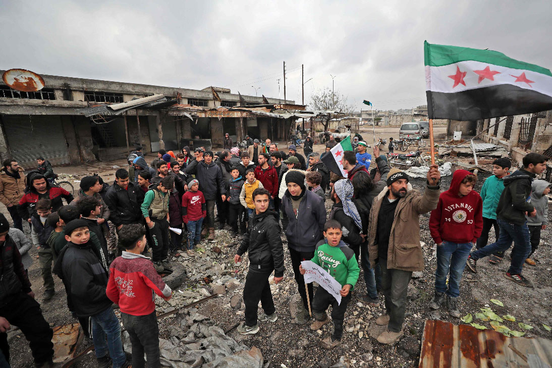 Syrians take part in a demonstration against the regime offensive in Syria's last major opposition bastion of Idlib