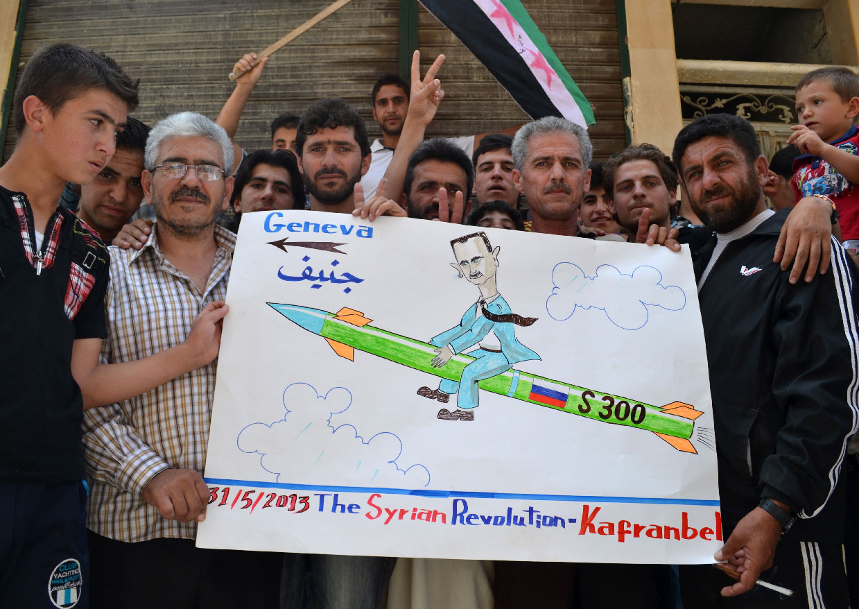 Photo taken on May 31, 2013 shows demonstrators holding a placard in Kafranbel, Idlib province