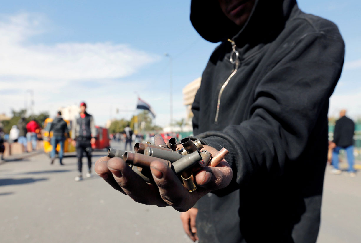 An Iraqi demonstrator shows the casings from bullets which were allegedly used by the Iraqi security forces