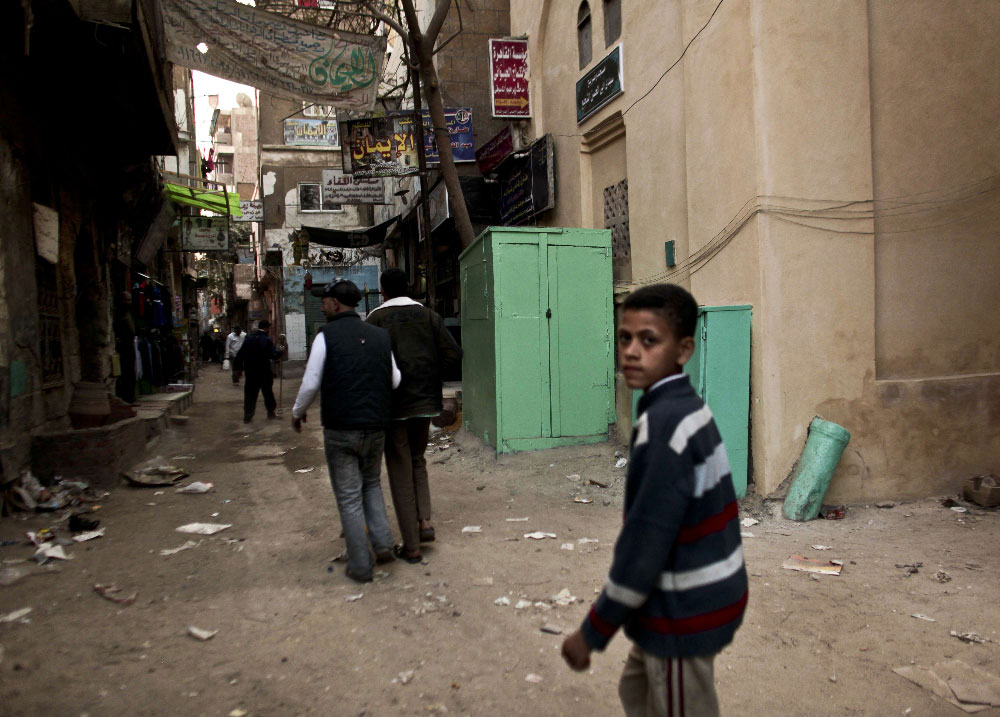 2012 photo shows a kiosk, center, used as a clinic where girls are circumcised by a barber in Giza, Egypt