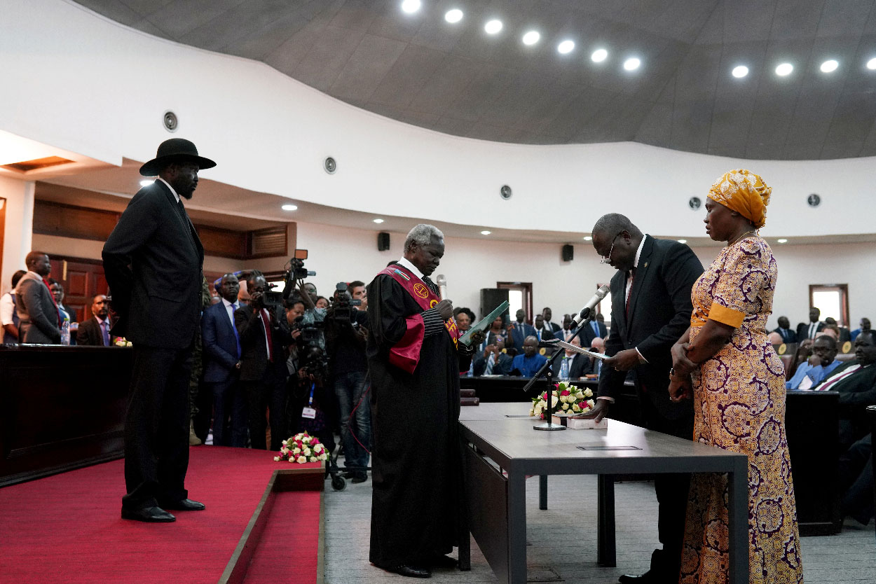 South Sudan's First Vice President Riek Machar takes the oath of office in front of President Salva Kiir