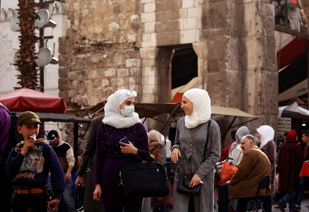 A woman wears a face mask as a preventive measure against the coronavirus, in old Damascus, Syria