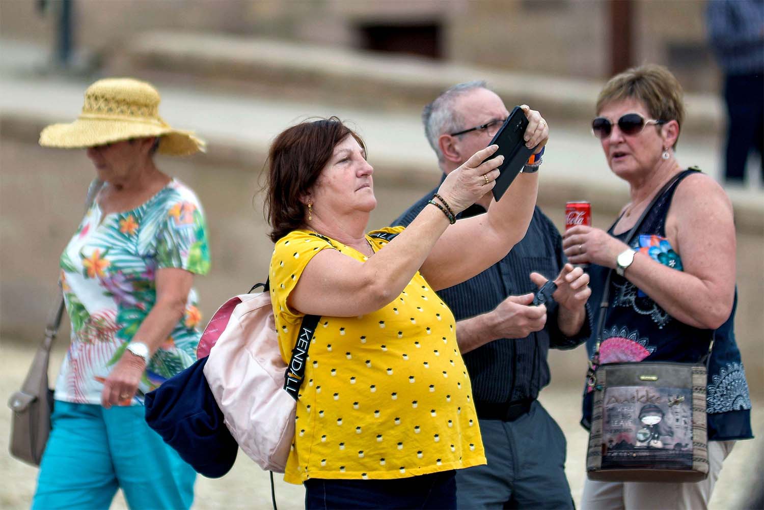 A tourist uses a phone to take pictures while on a visit to Luxor Temple in Egypt's southern city of Luxor 