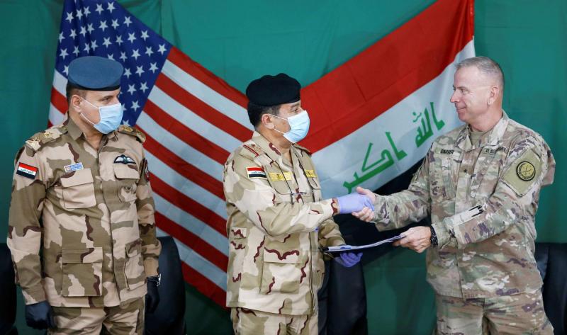 17 years on: US and Iraqi generals shake hands during the handover of Qayyarah Airfield West from US-led coalition forces to the Iraqi military