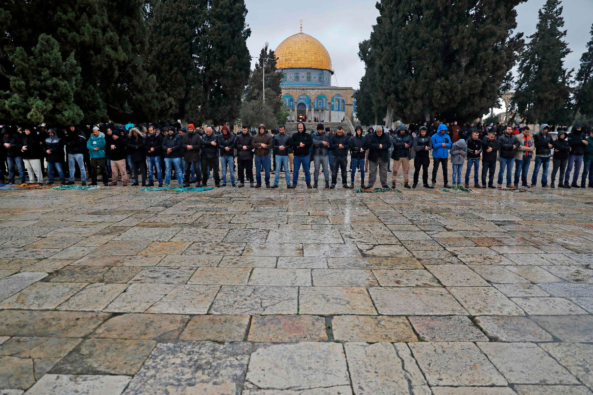 Palestinian Muslims pray in smaller numbers than usual during the weekly Friday noon prayer in Jerusalem
