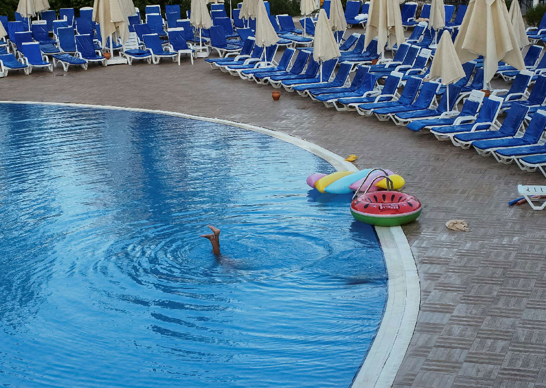 A tourist relaxes at a pool in the Mediterranean Sea resort near Bodrum, Turkey