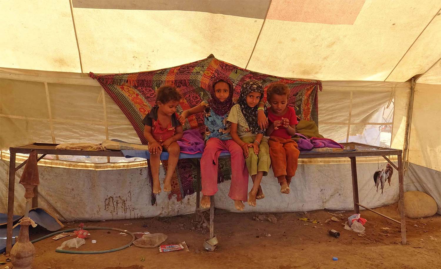 Yemeni children gather inside a tent at a camp for displaced people in the Khokha district of the western province of Hodeidah 