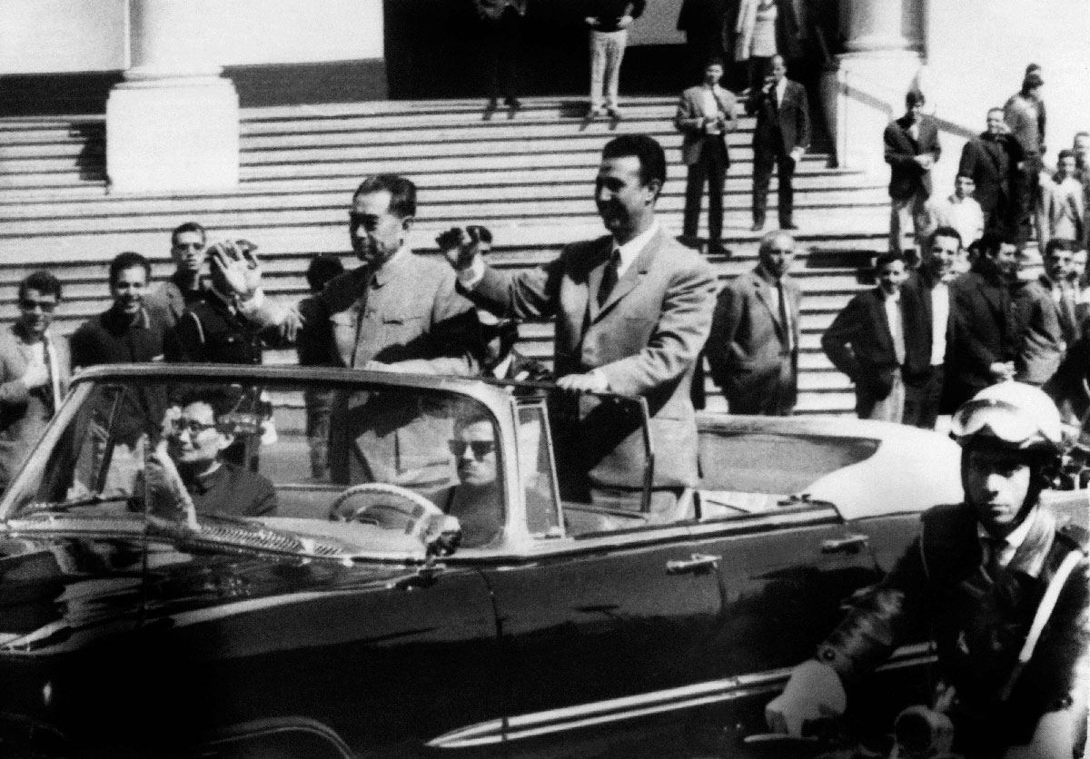 On March 31, 1965, Algerian President Ahmed Ben Bella (R) and Chinese Prime minister Chou En Lai wave to the crowd in Algiers